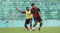 Samuel Balinsa (rompi kuning) coba merebut bola dari M Rafli pada pertandingan game internal Arema hari Rabu (07/06/2023). (Iwan Setiawan/Bola.com)