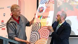 Menteri Pariwisata, Niall Blair, memberi papan surf ke pelatih Arsenal, Arsene Wenger di Museum Seni Kontemporer, Sydney, Selasa (11/7/2017). Arsenal melakukan tur pramusim ke Australia dengan melawan Sydney FC dan Sydney Wanderers. (EPA/David Moir)