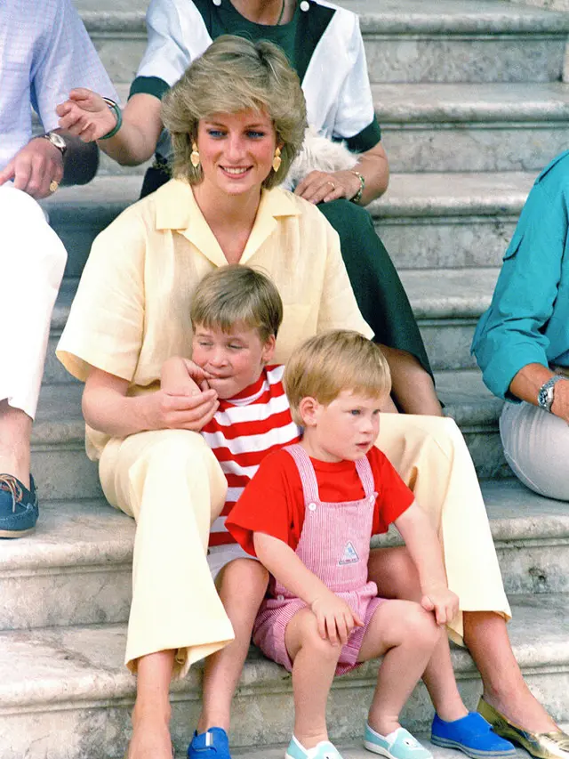 Putri Diana, yang mendapat gelar Princess of Wales bersama kedua putranya, duduk di tangga Istana Kerajaan di pulau Mallorca, Spanyol. (AP: Photo/John Redman, File )