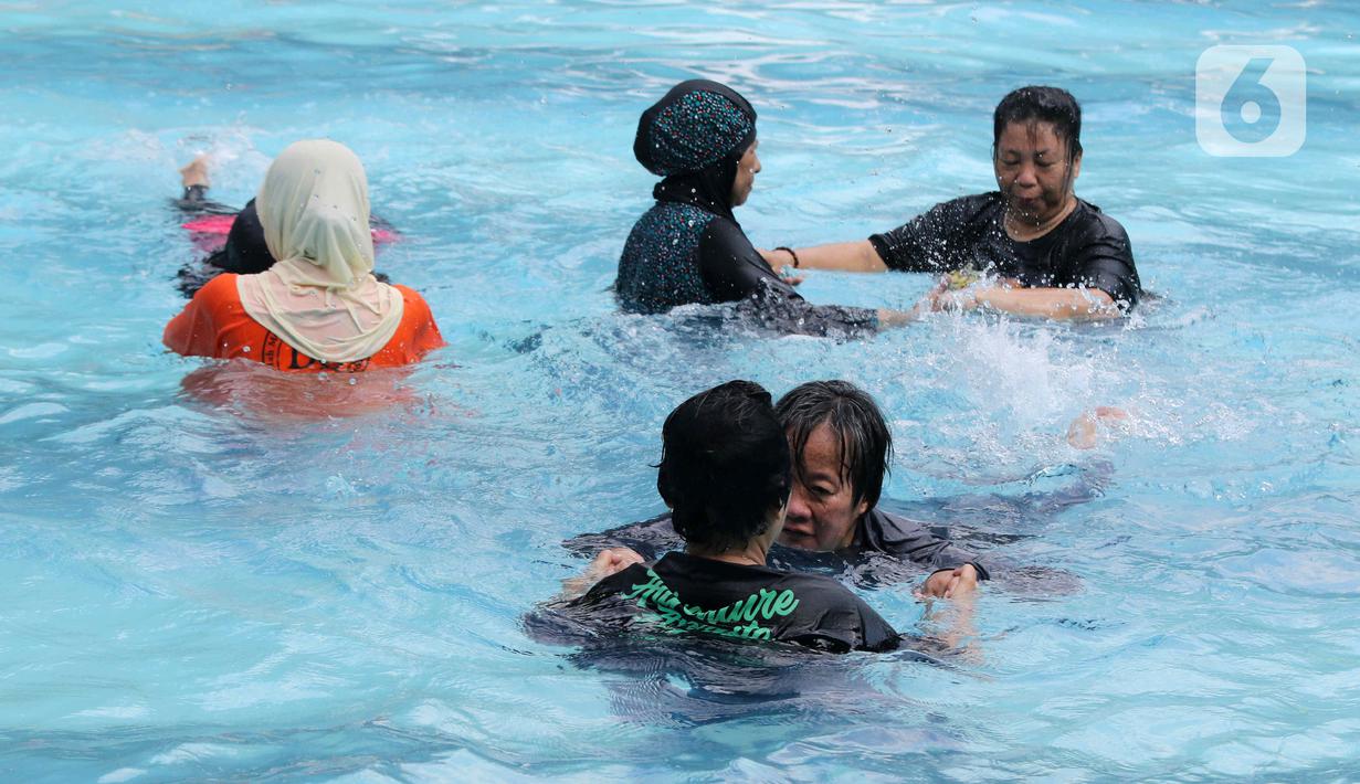 Sejumlah peserta berlatih berenang pada kegiatan Gerakan Prolanis Total (Gelato) di Gelanggang Remaja KONI, Gambir, Jakarta, Kamis (11/8/2022). Puskesmas Kecamatan Gambir mengadakan kegiatan Gelato berupa pelatihan berenang kepada peserta lansia penderita penyakit kronis untuk mencegah penyakit tersebut tambah parah. (Liputan6.com/Herman Zakharia)