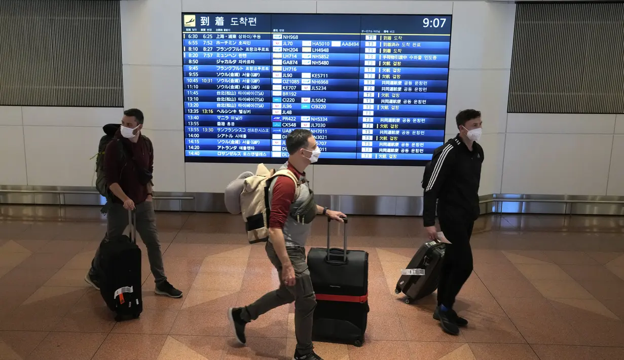 Wisatawan asing tiba di Bandara Internasional Haneda, Tokyo, Selasa (11/10/2022). Berbeda dengan banyak negara, masker wajah tetap digunakan hampir oleh seluruh masyarakat di Jepang, meskipun saat ini tidak ada kewajiban hukum untuk menggunakannya. (AP Photo/Eugene Hoshiko)