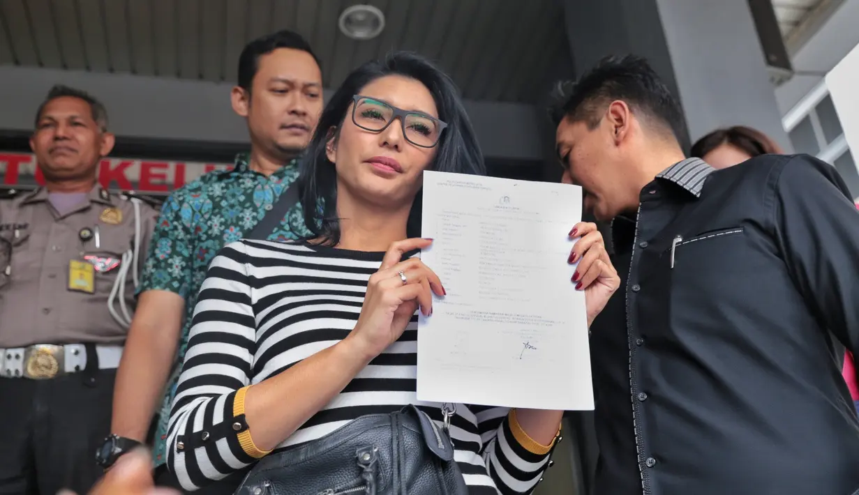 Istri dari Raiden Soedjono itu datang dengan menumpang mobil Alphard warna hitam. Dengan mengenakan kaos bergaris hitam putih. Tyas usai membuat laporan. (Adrian Putra/Bintang.com)