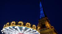 Sebuah foto menunjukkan Menara Eiffel di Paris diterangi dengan warna bendera nasional Ukraina, pada 9 Mei 2022. Memperingati Hari Eropa, Menara Eiffel memproyeksikan bendera Ukraina sebagai solidaritas untuk rakyat Ukraina di tengah invasi Rusia. (Ludovic MARIN / AFP)