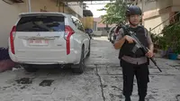 Polisi menjaga ketat penyidik KPK ketika menggeledah rumah pengusaha di Pekanbaru terkait korupsi jalan di Bengkalis. (Liputan6.com/M Syukur)