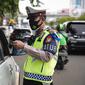 Polisi memeriksa surat-surat pengendara yang memasuki jalur khusus Transjakarta saat Operasi Zebra Jaya 2021 di kawasan Jalan Gatot Subroto, Jakarta, Selasa (16/11/2021). Operasi Zebra Jaya 2021 digelar untuk meningkatkan kedisiplinan masyarakat dalam berlalu lintas. (Liputan6.com/Faizal Fanani)