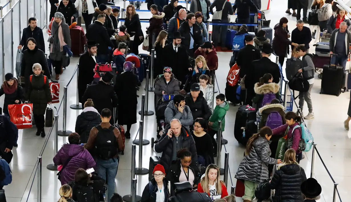 Antrean wisatawan untuk melakukan check in di Bandara Internasional John F. Kennedy, New York, Rabu (21/11). Masyarakat Amerika mulai bergegas pulang ke kampung halamannya alias mudik untuk merayakan Thanksgiving Day. (AP/Mark Lennihan)