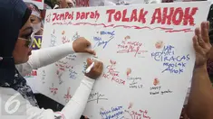 Massa dari Indonesia Bergerak menggelar aksi menolak Gubernur DKI, Basuki Tjahaja Purnama (Ahok) di Patung Arjuna Wiwaha, Jakarta, Kamis (22/9). Mereka membubuhkan cap jempol menggunakan darah sebagai simbol penolakannya. (Liputan6.com/Immanuel Antonius)