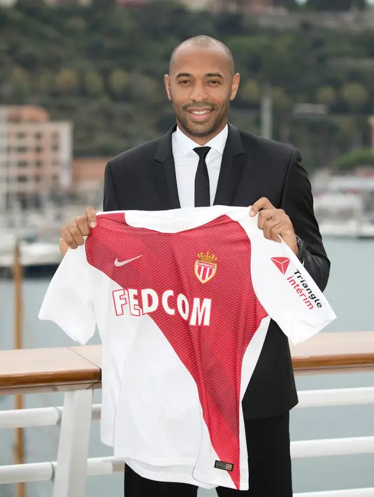 Pelatih AS Monaco, Thierry Henry menunjukkan jersey klubnya saat konferensi pers di Monako, Prancis, Rabu (17/10). Henry menggantikan Jardim yang baru saja dipecat Monaco awal musim ini. (AP Photo/Olivier Anrigo)