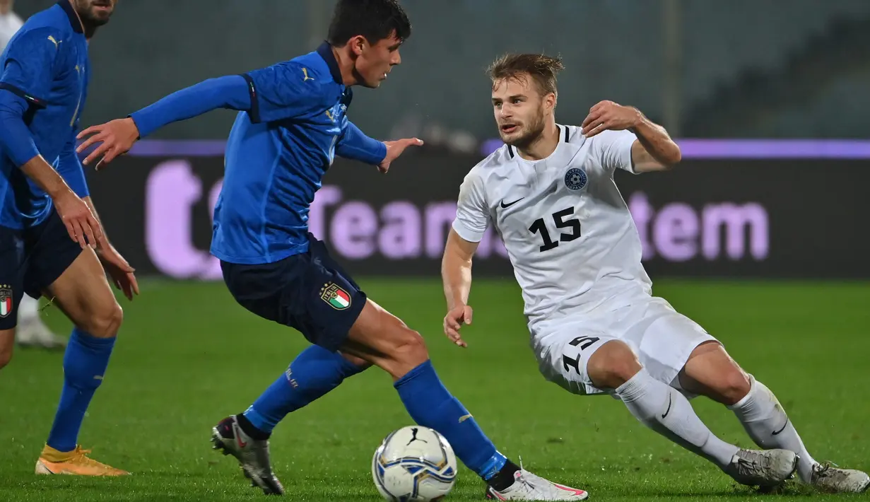 Gelandang Italia, Matteo Pessina (tengah) berebut bola dengan gelandang Estonia Rauno Sappinen (kanan) dalam laga uji coba internasional di Artemio Franchi, Kamis (12/11/2020) dini hari. Italia tanpa kesulitan mengalahkan Estonia dengan skor 4-0. (Alberto PIZZOLI/AFP)
