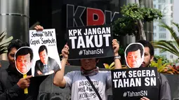 Aktivis Koalisi Masyarakat Sipil Anti Korupsi mengangkat tulisan saat aksi di depan Gedung KPK, Jakarta, Kamis (14/9). Mereka menuntut KPK segera menahan tersangka kasus dugaan korupsi KTP elektronik, Setya Novanto. (Liputan6.com/Helmi Fithriansyah)