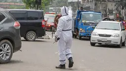Polisi mengenakan alat pelindung diri saat mengatur lalu lintas di Dhaka, Bangladesh, Senin (11/5/2020). Jalan-jalan utama Dhaka kembali ramai sehari setelah toko-toko dan pasar kembali dibuka secara terbatas mengikuti aturan pemerintah. (Xinhua/Stringer)