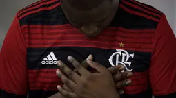 Seorang pria mengenakan jersey Flamengo berdoa saat Misa peringatan untuk para korban kebakaran di akademi sepakbola Brasil, di Rio de Janeiro, Brasil (8/2). Kebakaran tersebut menewaskan 10 pemain muda dan tiga luka-luka. (AP Photo/Leo Correa)