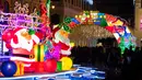 Karakter Sinterklas terlihat saat para wisatawan menyaksikan dekorasi Natal di Largo Do Senado, Makau, China, 22 Desember 2020. Largo do Senado atau Senado Square merupakan area perbelanjaan yang terkenal di Makau. (Xinhua/Cheong Kam Ka)