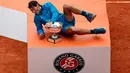Petenis Spanyol, Rafael Nadal berpose dengan pialanya setelah mengalahkan Dominic Thien dari Austria pada partai final Prancis Terbuka di Roland Garros, Minggu (10/6). Nadal merebut gelar juara Prancis Terbuka untuk kali ke-11. (AP/Christophe Ena)