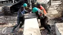 Sejumlah pekerja menyiapkan tiang pancang untuk pemasangan turap di Kali Ciliwung, Kampung Pulo, Jakarta (26/08/15). Pemprov DKI Jakarta menargetkan pemasangan turap selesai dalam waktu tiga bulan. (Liputan6.com/Gempur M Surya)