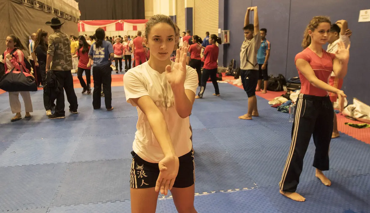 Sejumlah karateka putri melakukan pemanasan sebelum tampil pada Kejuaraan Dunia Karate Junior, Cadet, dan U-21 2015. (Bola.com/Vitalis Yogi Trisna)