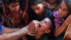 Seorang anak diberi vaksin kolera oleh sukarelawan Bangladesh di kamp pengungsi Thankhali di distrik Ukhia (10/10). Di tengah kekhawatiran wabah, PBB memberikan vaksinasi kolera untuk hampir satu juta orang Rohingya. (AFP Photo/Indranil Mukherjee)