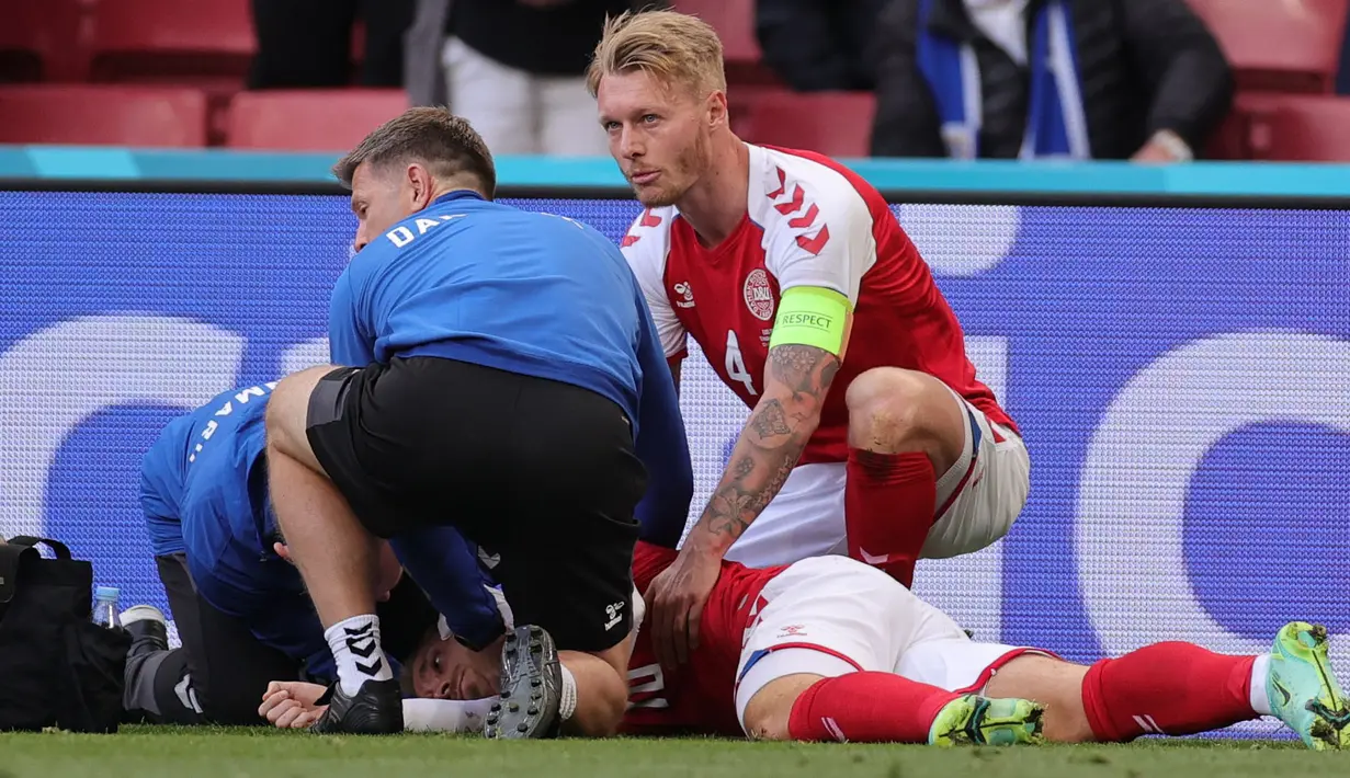 Simon Kjaer adalah orang paling berjasa pada momen ini. Kapten Denmark ini langsung memberikan pertolongan pertama dengan cara memastikan lidah Eriksen tidak menggangu pernafasannya. Selain itu ia juga menenangkan istri Eriksen yang sangat cemas di pinggir lapangan. (Foto: AFP/Pool/Friedemann Vogel)