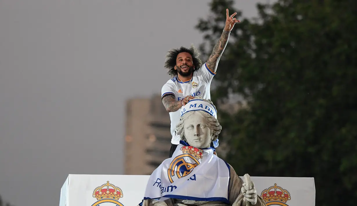 <p>Bek Real Madrid, Marcelo melakukan selebrasi di atas patung dewi Cibeles usai Real Madrid meraih gelar juara La Liga Spanyol usai mengalahkan Espanyol di Madrid, Spanyol pada 30 April 2022. Real Madrid mengamankan gelar La Liga ke-35  setelah kemenangan kandang 4-0 atas Espanyol. (AFP/Oscar Del Pozo)</p>