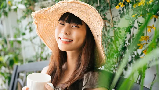 senyum santai minum kopi teh