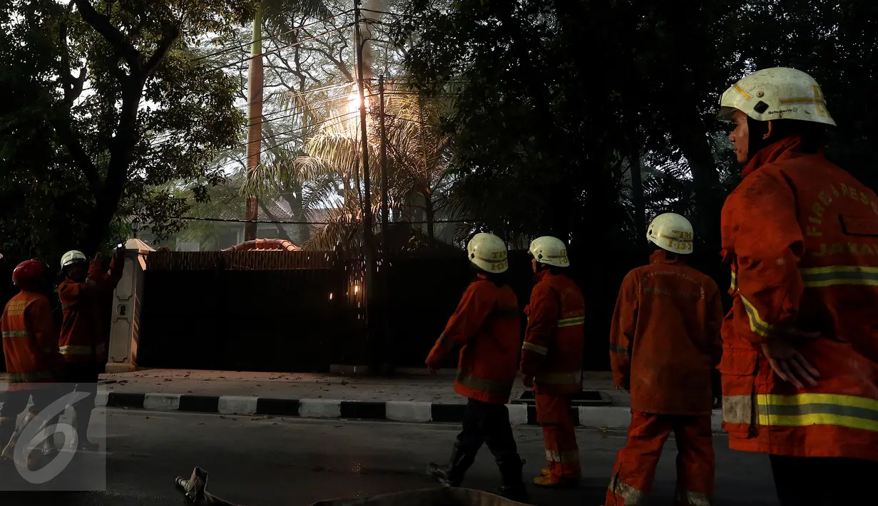 Petugas kebakaran berusaha memantau percikan api yang keluar dari kabel listrik setelah hujan deras mengguyur sore ini, di Jalan Imam Bonjol No 2, Jakarta, Selasa (28/3). Percikan tersebut di duga dari konsleting listrik. (Liputan6.com/JohanTallo)