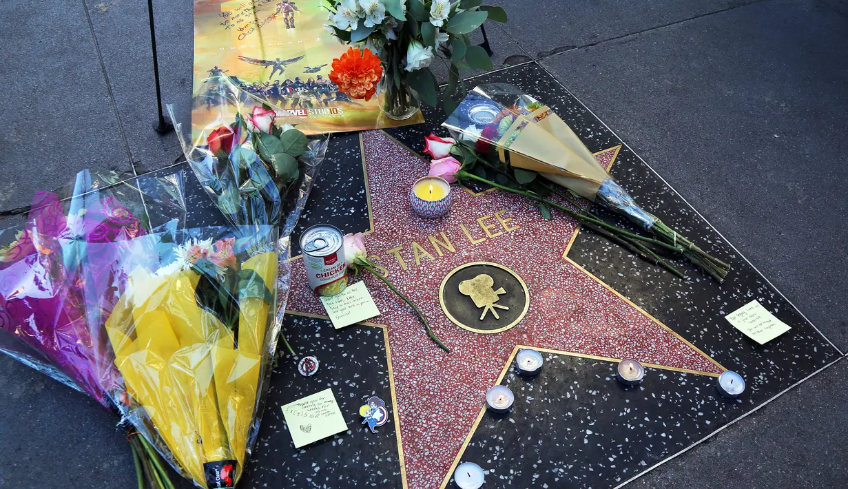 Karangan bunga dan memorabilia menghiasi bintang Walk of Fame milik legenda Marvel, Stan Lee di California, Senin (12/11). Stan Lee, kreator Captain America dan beberapa tokoh superhero Marvel lainnya, meninggal dunia di usia 95 tahun. (AP/Reed Saxon)