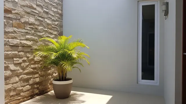 Inspirasi Teras Rumah Subsidi dengan Batu Alam dan Palem Kuning (AI Generated)