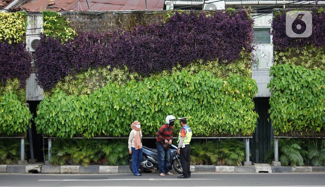 Polisi menghentikan pengendara sepeda motor saat Operasi Yustisi Protokol Covid-19 di kawasan Tugu Tani, Jakarta, Senin (14/9/2020). Operasi tersebut digelar sebagai langkah untuk menekan penyebaran Covid-19 di masa PSBB Jakarta. (Liputa6.com/Immanuel Antonius)