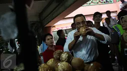 Cagub DKI Jakarta Anies Rasyid Baswedan mencium kelapa saat kunjungi Pasar Tebet Timur, Jakarta, Jumat (28/10). Kunjungan Anis tersebut untuk melihat suasana pasar tradisional serta sebagai kampanye Pilgub DKI Jakarta 2017. (Liputan6.com/Faizal Fanani)