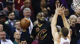 Aksi pemain Cleveland Cavaliers, LeBron James #23 mengamankan bola sebelum out saat dihadang pemain Los Angeles Clippers, Blake Griffin #32 pada laga NBA 2016-2017 di Quicken Loans Arena, (1/11/2016). (AP/Ron Schwane)