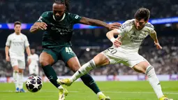 Bertanding di Santiago Bernabeu, Rabu 11 Maret 2026 waktu setempat atau Kamis 12 Maret 2026 dini hari WIB, kedua tim bermain cukup intens. Tampak dalam foto, pemain Manchester City, Antoine Semenyo (kiri) berebut bola dengan Fran Garcia (Real Madrid) saat pertandingan leg pertama babak 16 besar Liga Champions 2025/2026 di stadion Santiago Bernabeu, Rabu 11 Maret 2026 waktu setempat atau Kamis 12 Maret 2026 dini hari WIB. (AP Photo/Jose Breton)