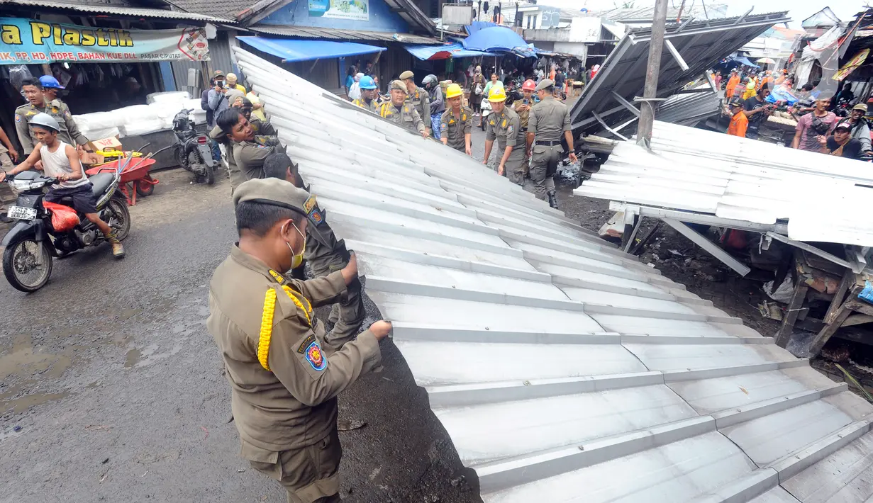 Petugas Satuan Polisi Pamong Praja (Satpol PP) Kota Tangerang Selatan membongkar lapak pedagang kaki lima (PKL) di luar area Pasar Ciputat, Tangerang Selatan, Banten, Selasa (14/2/2023). Penertiban ini ditujukan untuk puluhan lapak PKL di sekitar Jalan Aria Putera, Jalan H. Usman, Jalan Bancet, dan kawasan Polikarbonat karena keberadaannya mengganggu ketertiban umum di antaranya kemacetan lalu lintas. (merdeka.com/Arie Basuki)