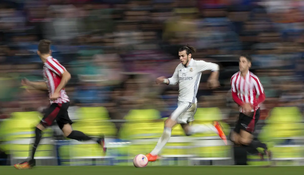 Aksi Gareth Bale saat menggiring bola melewati hadangan pemain Athletic Bilbao pada lanjutan La Liga di Santiago Bernabeu stadium, Madrid, senin (23/10/16) dini hari WIB. (AP/Daniel Ochoa de Olza)