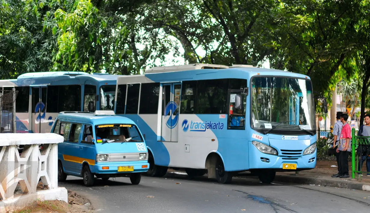 Bus pengumpan atau feeder bus Transjakarta sedang ngetem menunggu penumpang di seberang Stasiun Tebet , Jakarta, Kamis (7/4). Pengoperasian ini bagian dari antisipasi penumpukan penumpang saat perlintasan KRL Tebet ditutup. (Liputan6.com/Yoppy Renato)