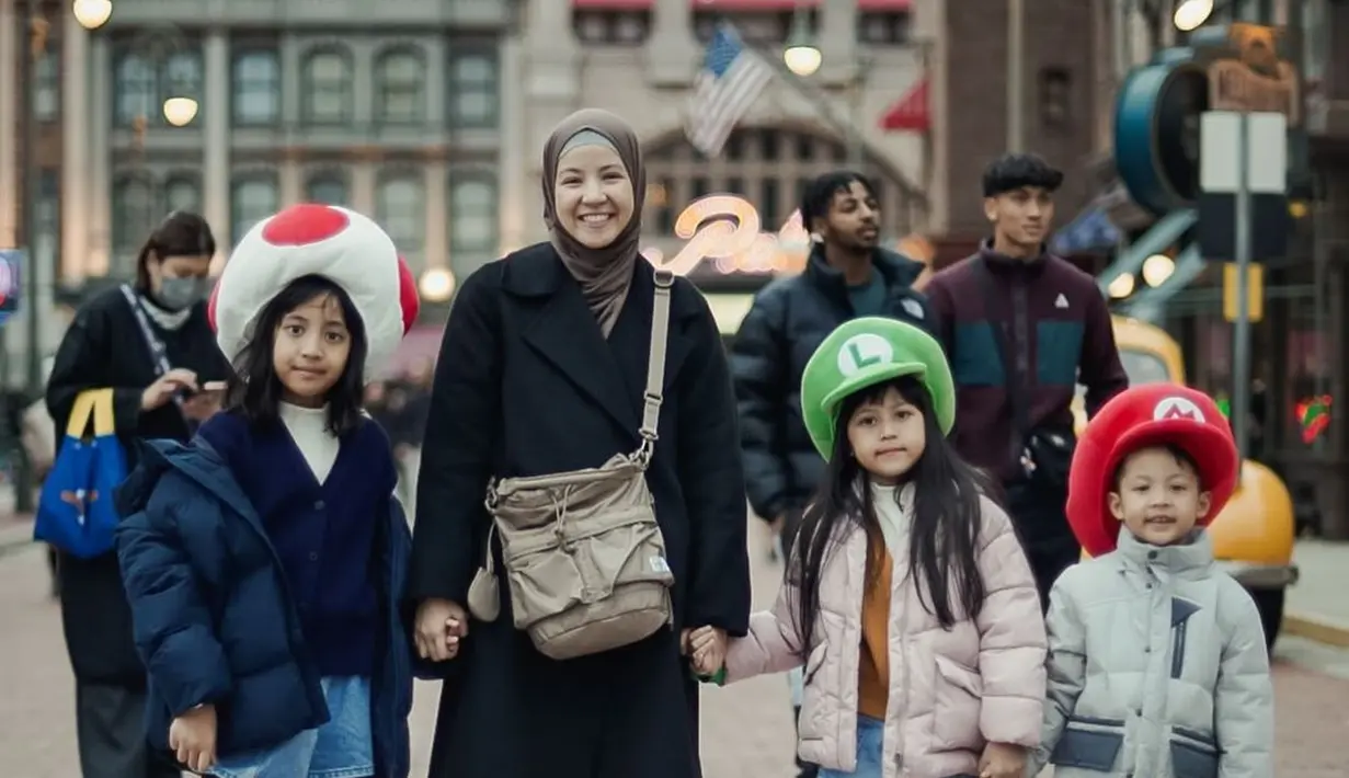 <p>Lagi-lagi Natasha Rizky kenakan outfit monokrom di Universal Studio Jepang. Ia kenakan long coat hitam dengan celana navy dan sling bag cokelat [@natasharizkynew]</p>