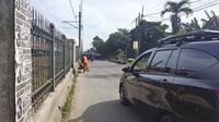 Salah seorang Pesapon membersihkan jalan di Jalan Raya Citayam, Kecamatan Cipayung, Kota Depok. (Liputan6.com/Dicky Agung Prihanto)
&nbsp;