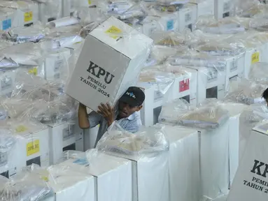 Petugas mengangkat logistik Pemilu 2024 dari Gelanggang Olahraga (GOR) Kecamatan Tanah Abang untuk dibawa menuju Balai RW 04 Benhil, Jakarta Pusat, Selasa (13/2/2024). (merdeka.com/Imam Buhori)