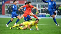 Aksi bintang Timnas China, Wu Lei (merah) saat menghadapi hadangan dari kiper Timnas Singapura, Hassan Sunny di putaran kedua Kualifikasi Piala Dunia 2026. (AFP).