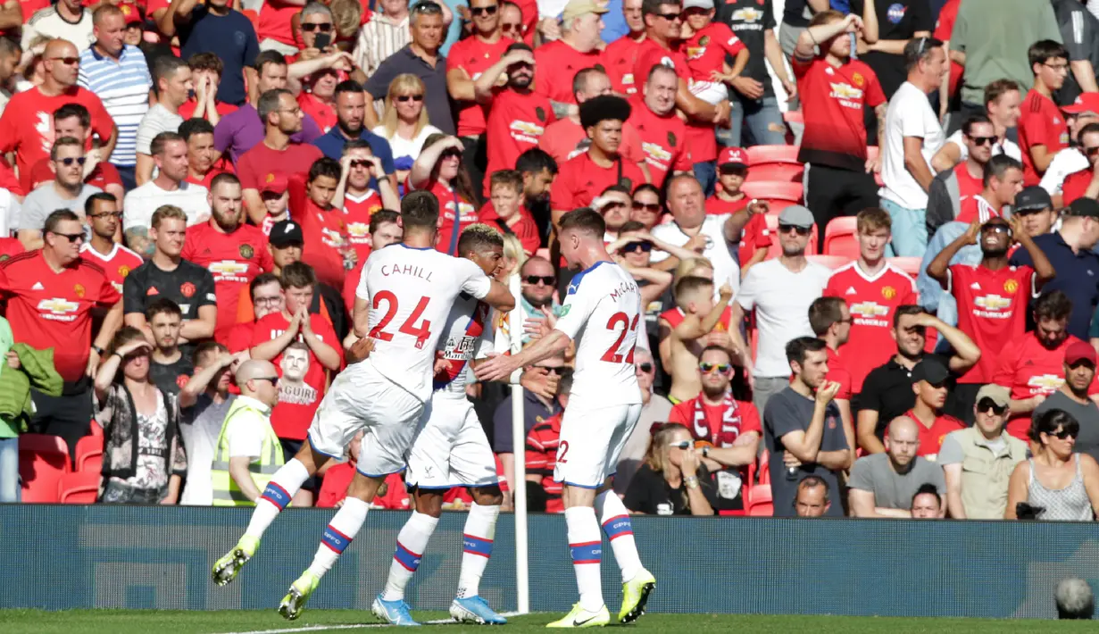 Para pemain Crystal Palace merayakan gol yang dicetak Patrick van Aanholt ke gawang Manchester United pada laga Premier League di Stadion Old Trafford, Manchester, Sabtu (24/8). MU kalah 1-2 dari Palace. (AFP/Lindsey Parnaby)