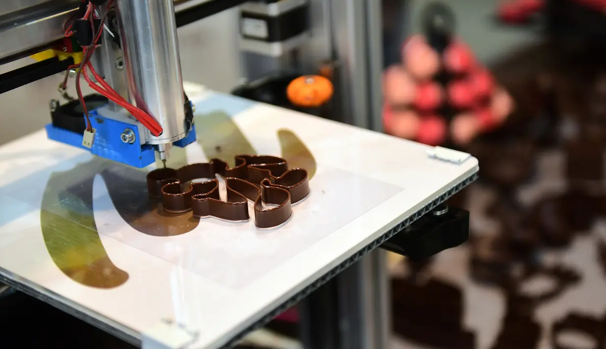 Sebuah mesin pencetak 3 dimensi sedang bekerja membuat coklat dalam acara Brussels Chocolate Fair di Brussels, Belgia (10/2). (AFP/Emmanuel Dunand)