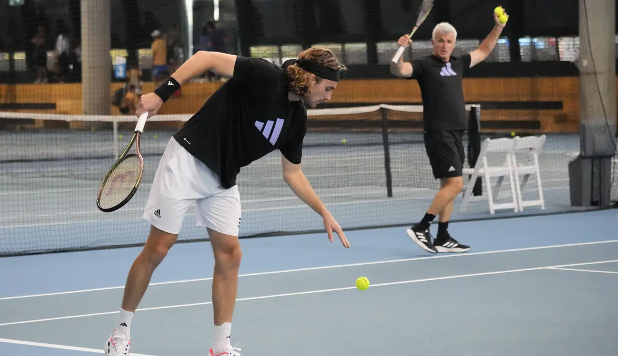Stefanos Tsitsipas dari Yunani didampingi ayah sekaligus pelatihnya, Apostolos saat sesi latihan menjelang final putra kejuaraan tenis Australia Open 2023 di Melbourne, Australia, Sabtu, 28 Januari 2023. Petenis 24 tahun itu melangkah ke final usai menyingkirkan wakil Rusia, Karen Kachanov empat set 7(7)-6(2), 6-4, 6(6)-7(8), dan 6-3 pada semifinal di Rod Laver Arena. (AP Photo/Dita Alangkara)