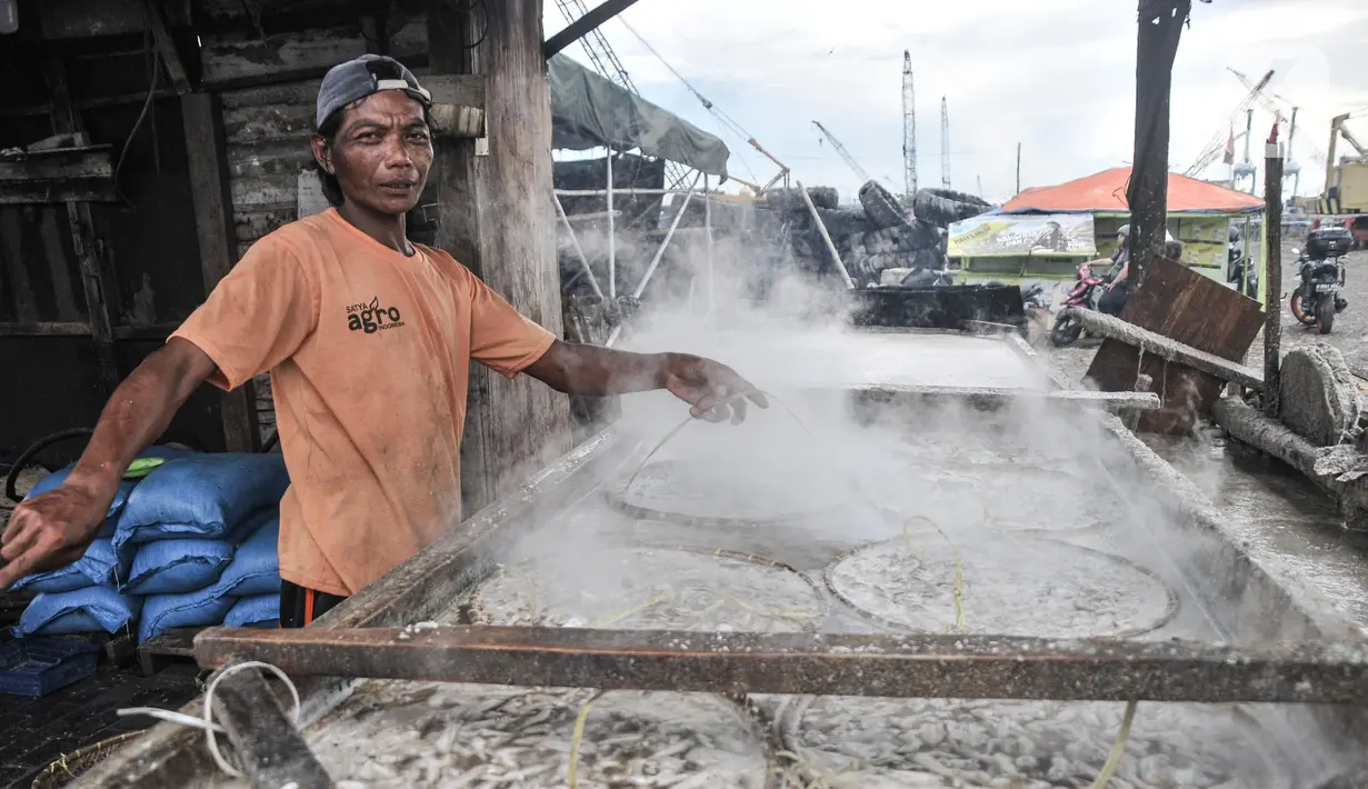 Pekerja saat menyelesaikan pembuatan ikan asin di kawasan pesisir Cilincing, Jakarta Utara, Minggu (12/6/2022). Pengusaha ikan asin setempat menungkapkan harga jual mengalami penurunan dibandingkan minggu sebelumnya akibat merosotnya daya beli masyarakat. (merdeka.com/Iqbal S. Nugroho)