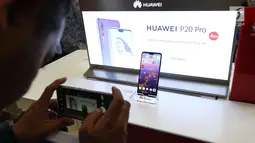 Seorang pengunjung mengabadikan ponsel Huawei P20 Pro di Jakarta, Kamis (28/6). Huawei P20 Pro resmi dipasarkan dan dibanderol seharga Rp 11.999.000 di Indonesia. (Liputan6.com/Angga Yuniar)