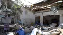Seorang pria berdiri di tengah reruntuhan bangunan yang hancur akibat ledakan bom mobil di Mogadishu, Somalia (28/3). Insiden tersebut telah menyebabkan 11 orang tewas dan belasan lainnya terluka. (Reuters/Feisal Omar)