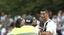 Seorang suporter berusaha memeluk penyerang Juventus, Cristiano Ronaldo selama pertandingan persahabatan antara Juventus A dan tim B, di Villar Perosa, Italia utara, (12/8). Pada pertandingan ini Ronaldo mencetak satu gol. (AFP Photo/Isabella Bonotto)