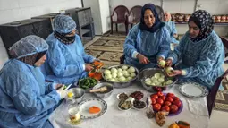 Para wanita membuat maftoul atau couscous di Khan Yunis, Jalur Gaza, Palestina, 10 Januari 2022. Secara tradisional, makanan ini dimasak menggunakan alat kukus. (SAID KHATIB/AFP)