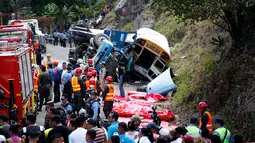 Petugas medis dan pemadam berdatangan ke lokasi kecelakaan antara sebuah bus dengan truk di pinggiran Ibu Kota Honduras, Tegucigalpa, Minggu (5/2). Belum diperoleh keterangan lebih detail mengenai kecelakaan tersebut. (AP Photo/Fernando Antonio)