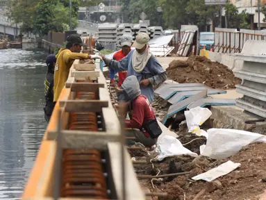  Para pekerja menyelesaikan pembangunan turap di sepanjang Kali Grogol, Jakarta, Senin (21/11). Pembangunan turap dilakukan untuk mencegah meluapnya air kali saat hujan dan ditargetkan selesai 20 Desember 2016. (Liputan6.com/Gempur M Surya)