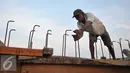 Pekerja menyelesaikan proyek pembangunan tanggul di Pantai Muara Baru, Jakarta, Rabu (2/12). Proyek pembangunan tanggul tersebut bertujuan untuk menahan banjir rob yang sering melanda kawasan Muara Baru. (Liputan6.com/Gempur M Surya)