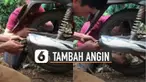 Cara unik ditunjukkan oleh beberapa lelaki ini ketika memanfaatkan knalpot motor untuk menambah angin ban.